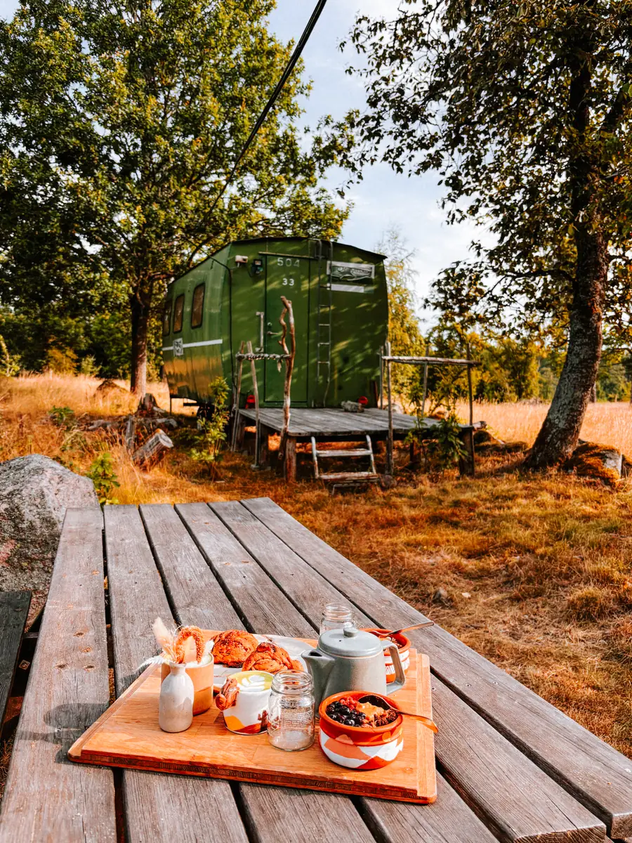 Breakfast on the table in front of Julia's offgrid cabin in Småland