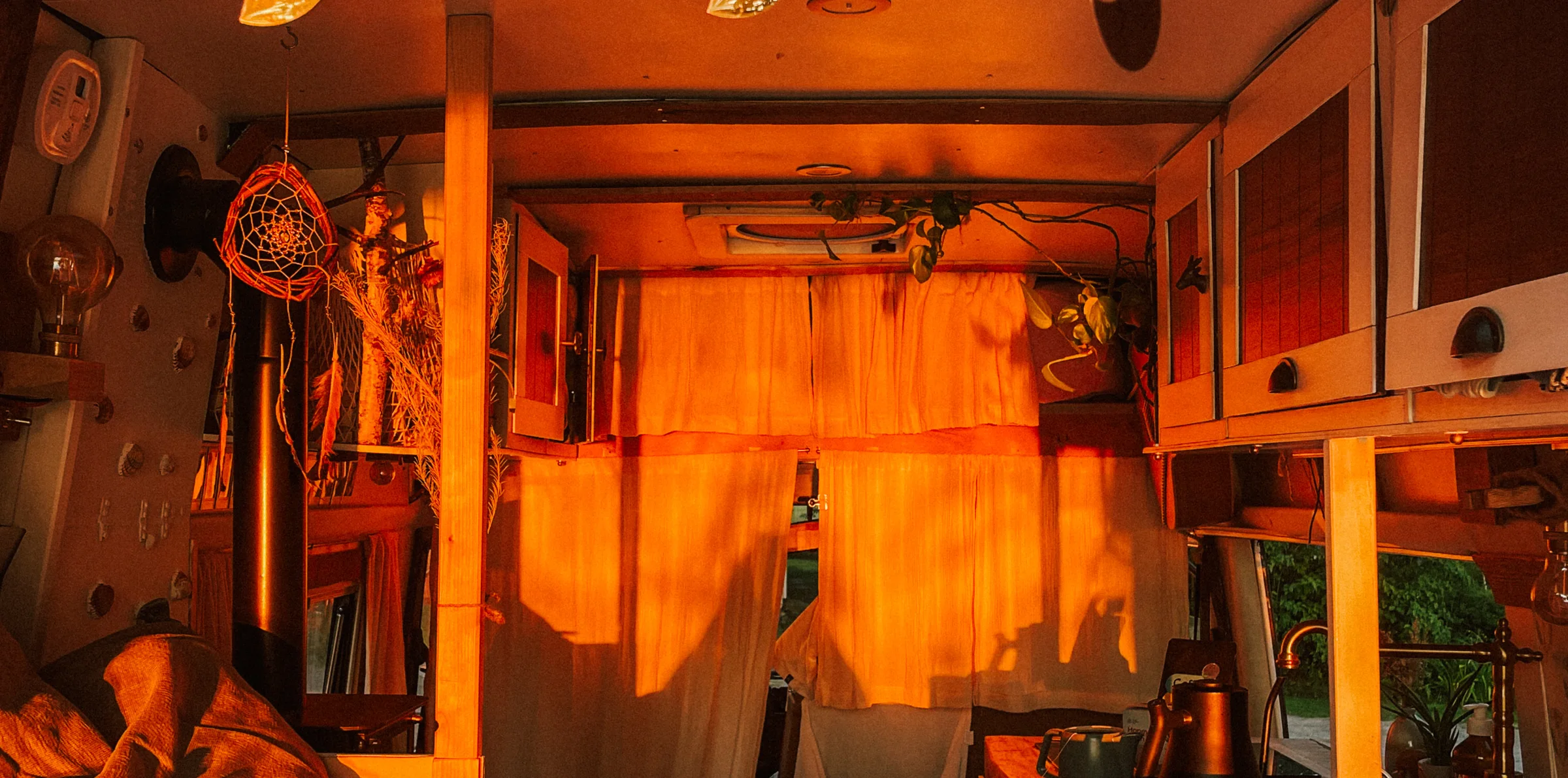 The inside of the camper glowing orange in the evening sun