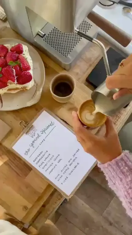 Cake, coffee and the handwritten café menu on the table in the camper