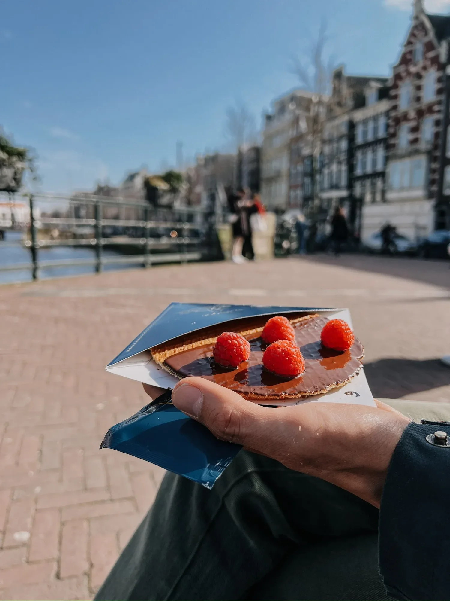 a berry stroopwafel by the canal