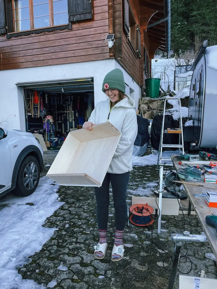 evelyne carrying a drawer through the snow