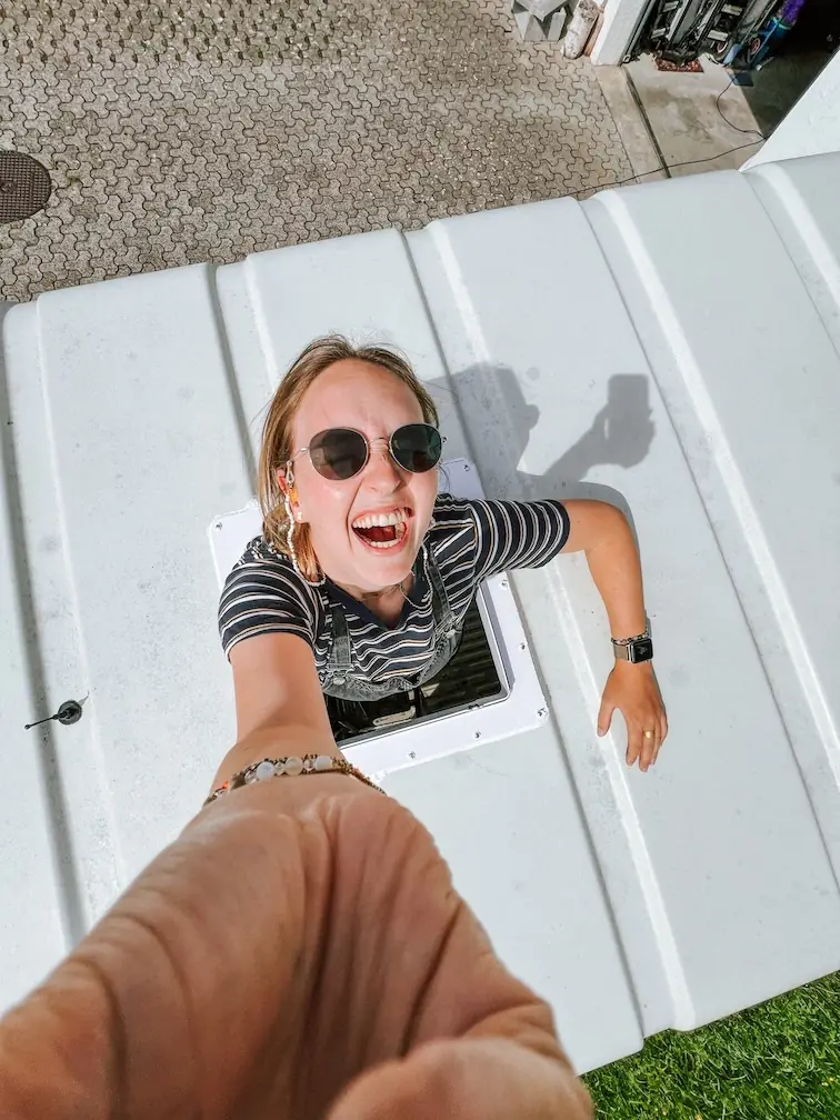 evelyne looking up through the hole for the roof fan