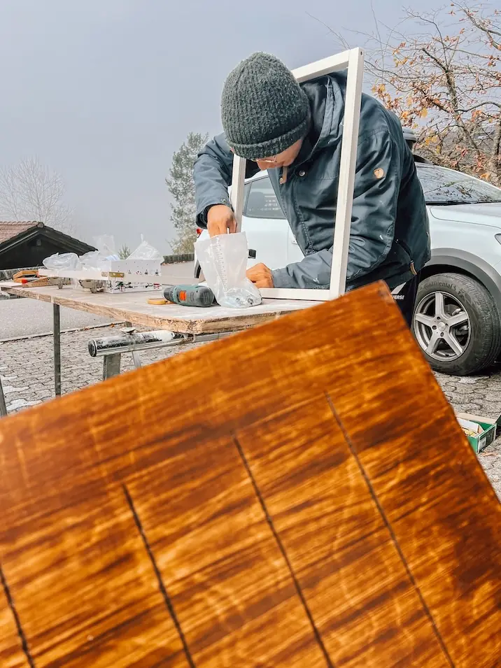 frank fitting the panel into its frame