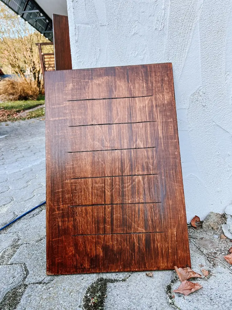 a finished wooden panel leaning against a wall