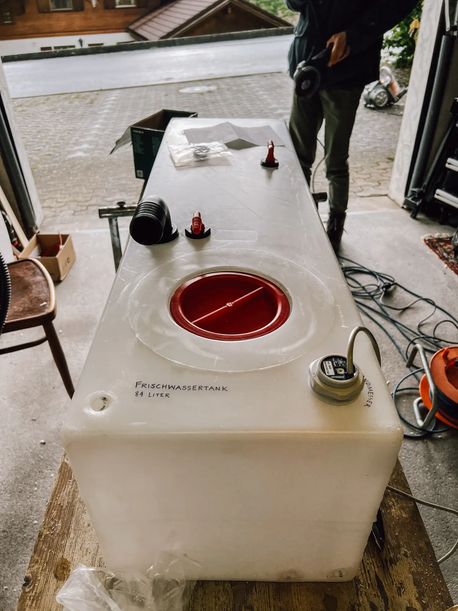 our fresh water tank with a large opening closed by a red lid
