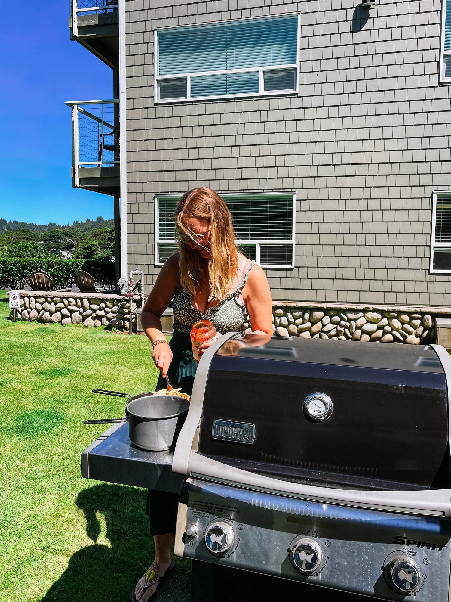ready for lunch on the beach? evelyne, pouring tomato sauce over the fettuccine