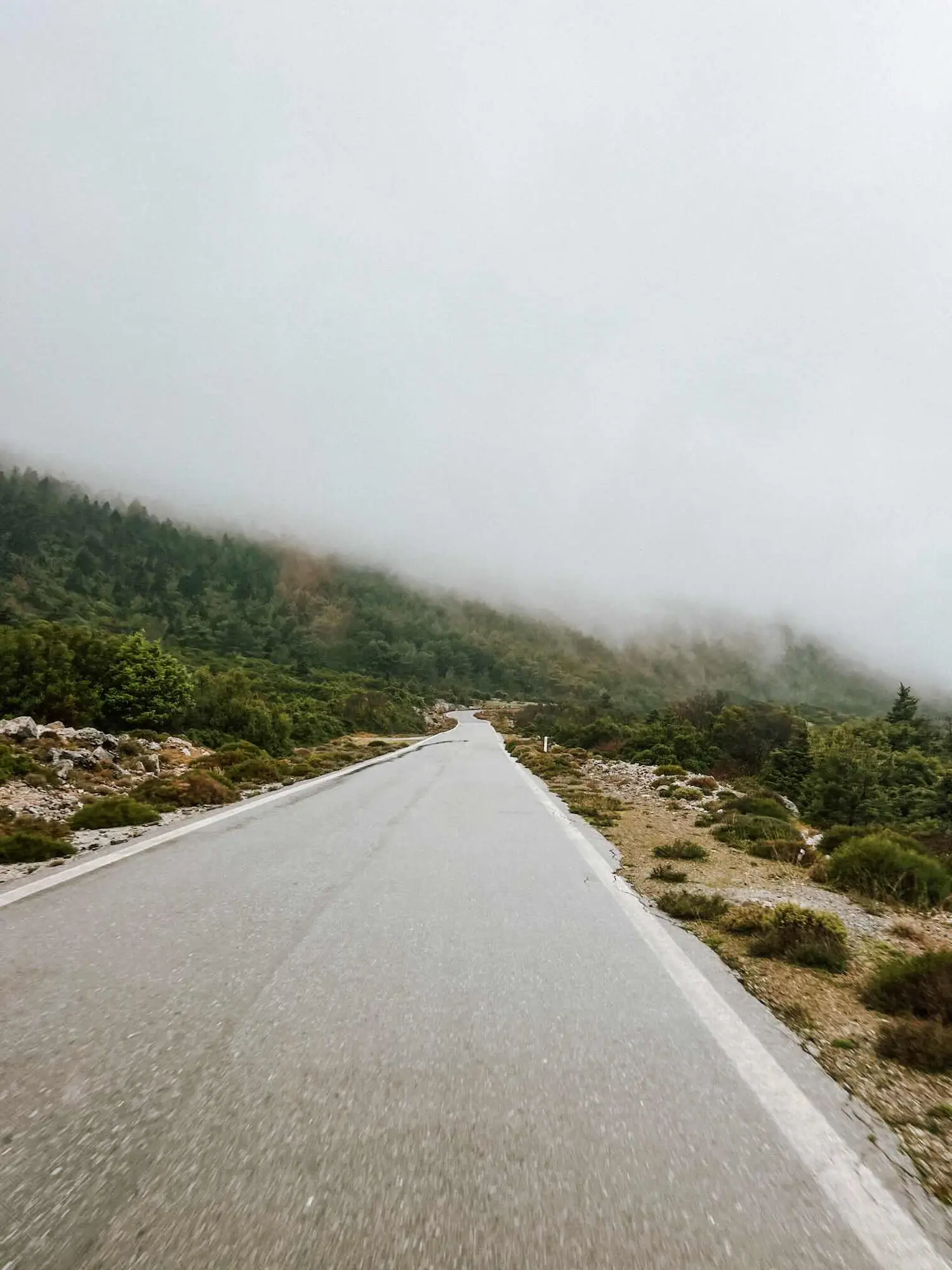 a mountain road winding toward monemvasia