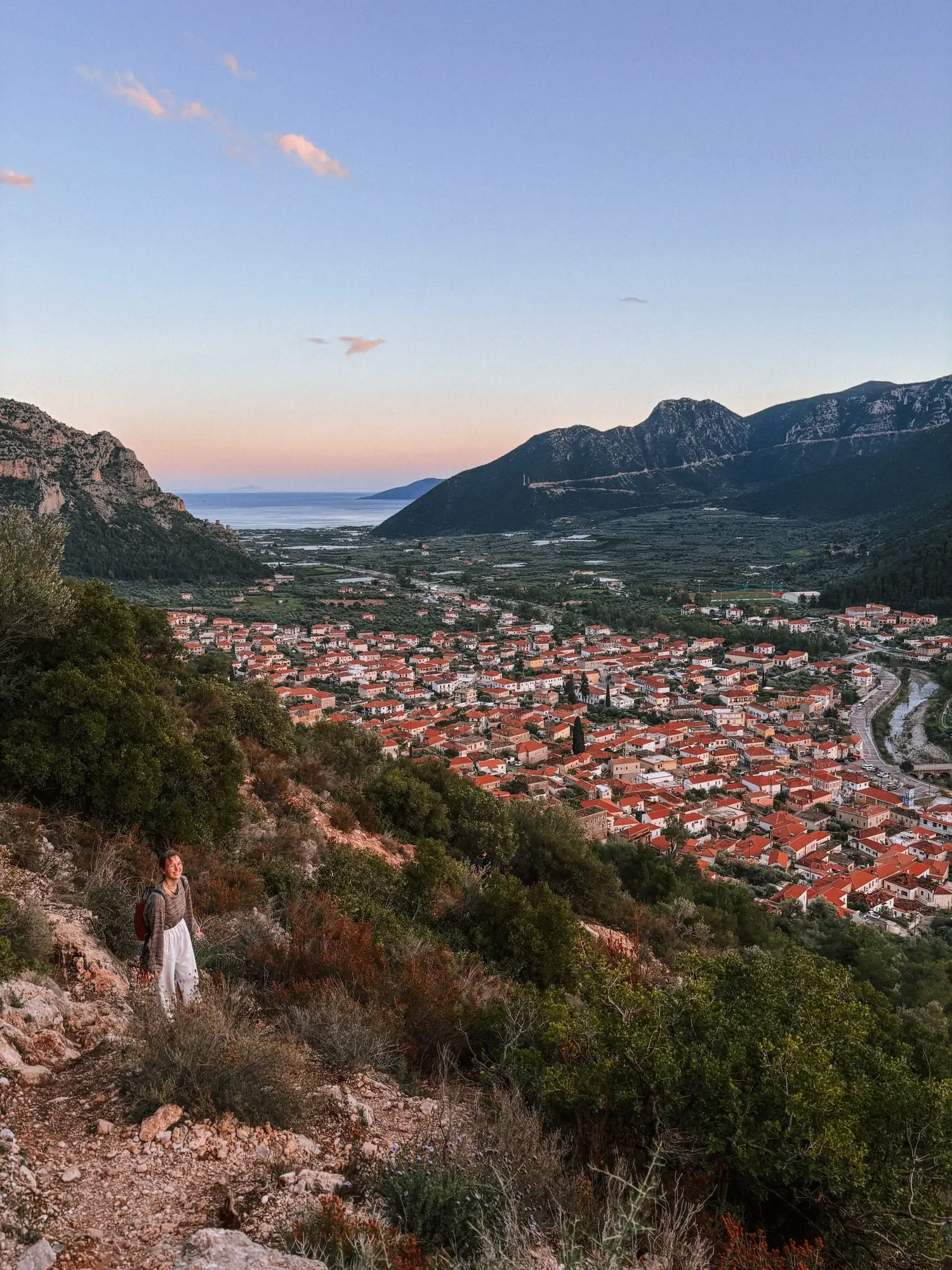 a view over leonidio and its red cliffs