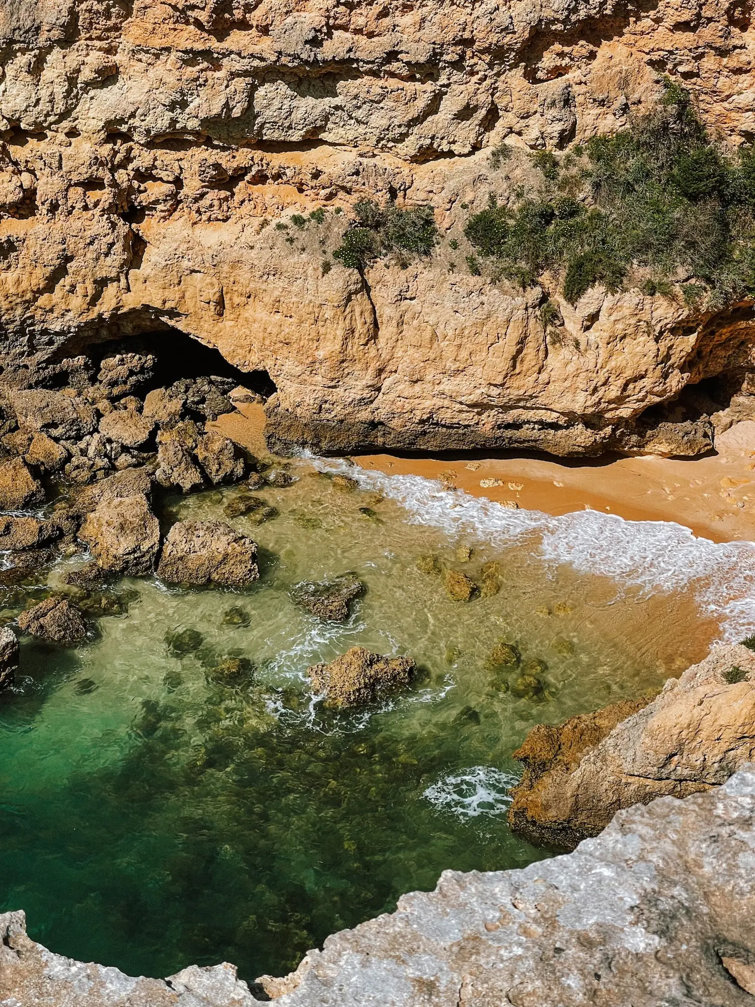 a cove on the algarve with emerald water