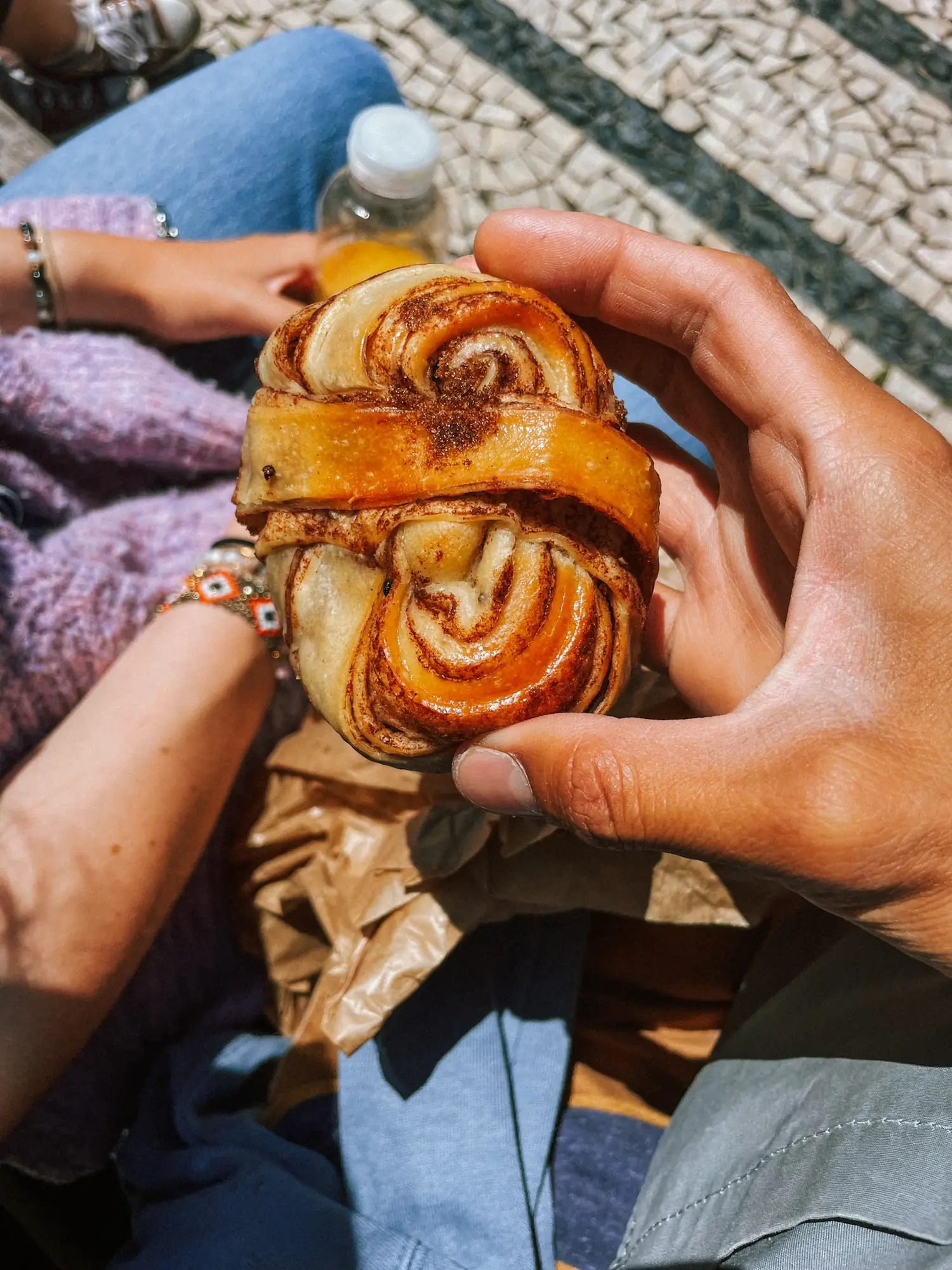 a cinnamon bun on a café table in porto