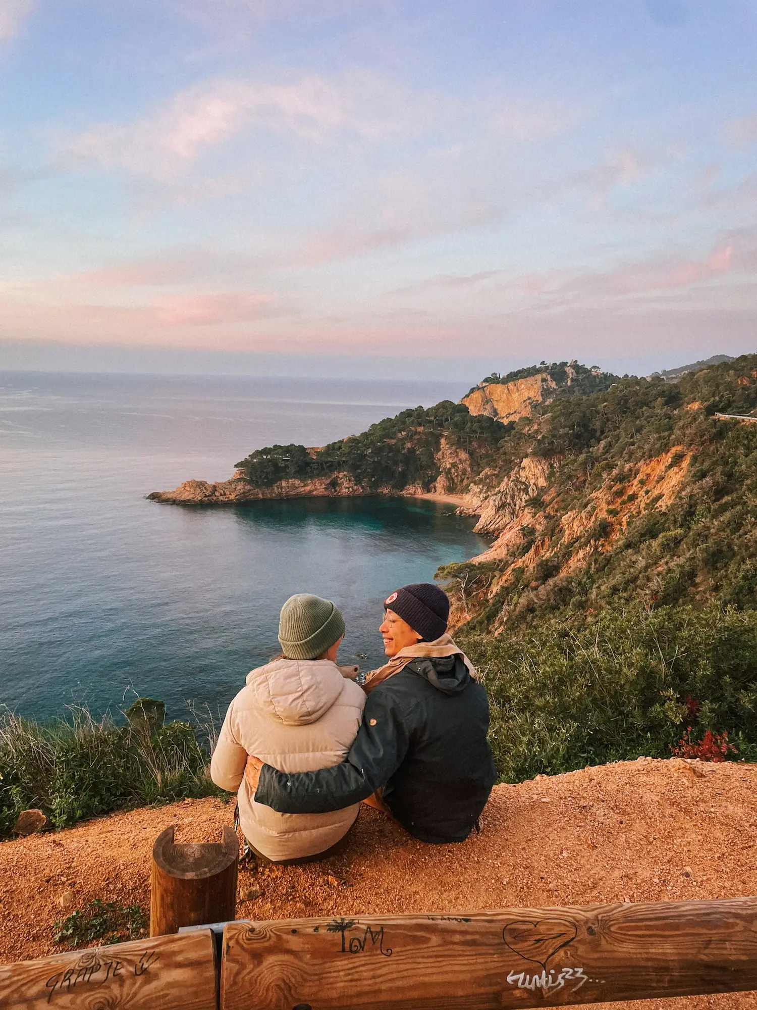 frank and evelyne sitting above a cove on the costa brava