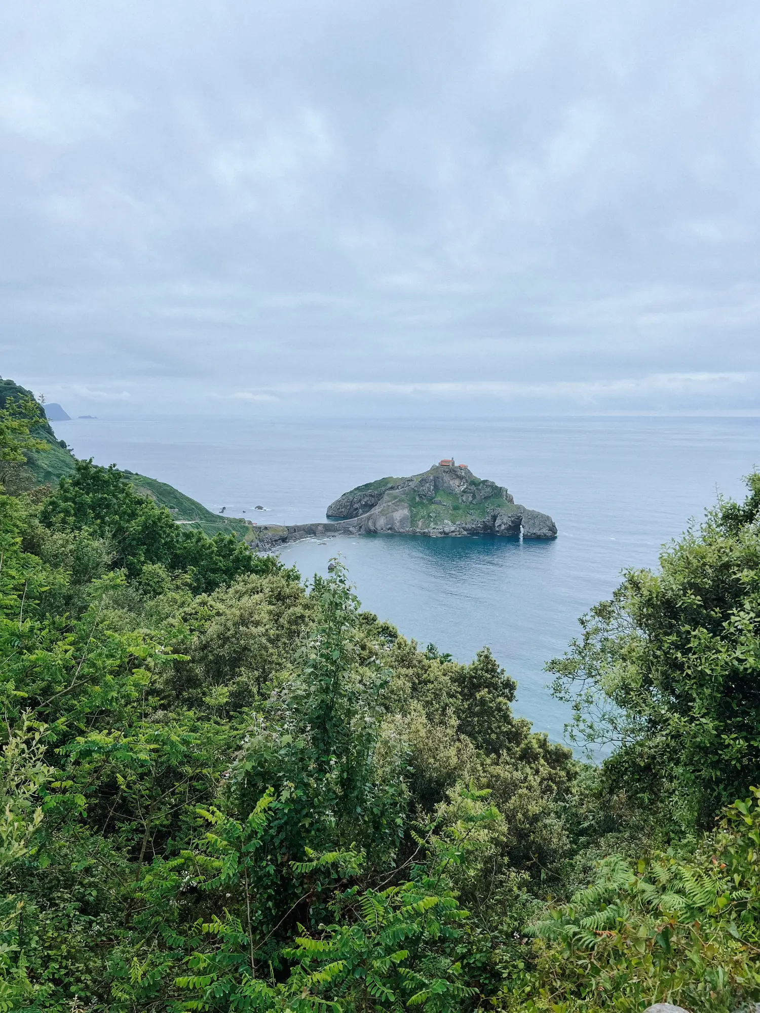 a small island off the green coast near gaztelugatxe
