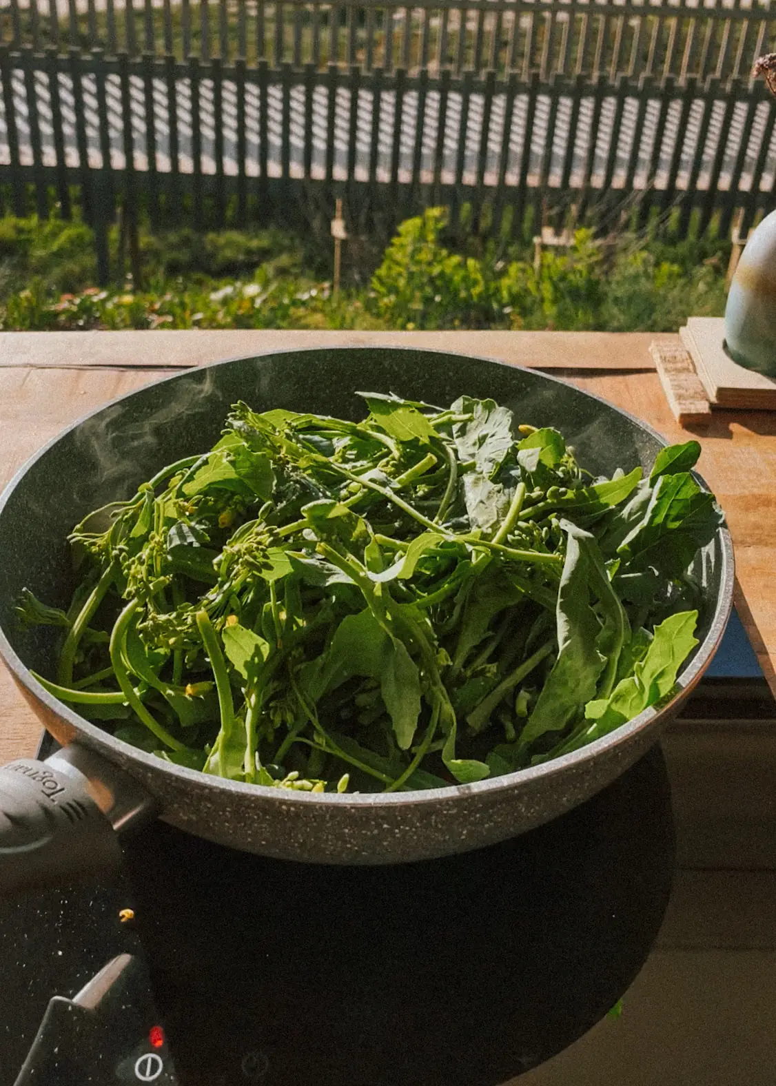 a pan of grelos on the induction cooktop