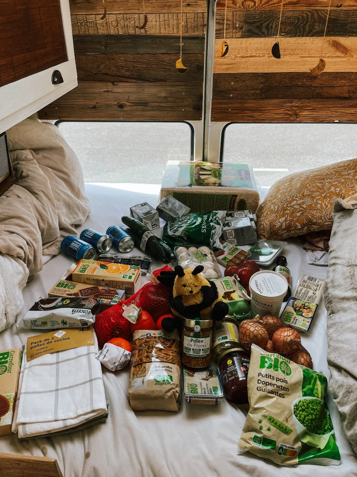 a week of groceries spread out on the bed in the van