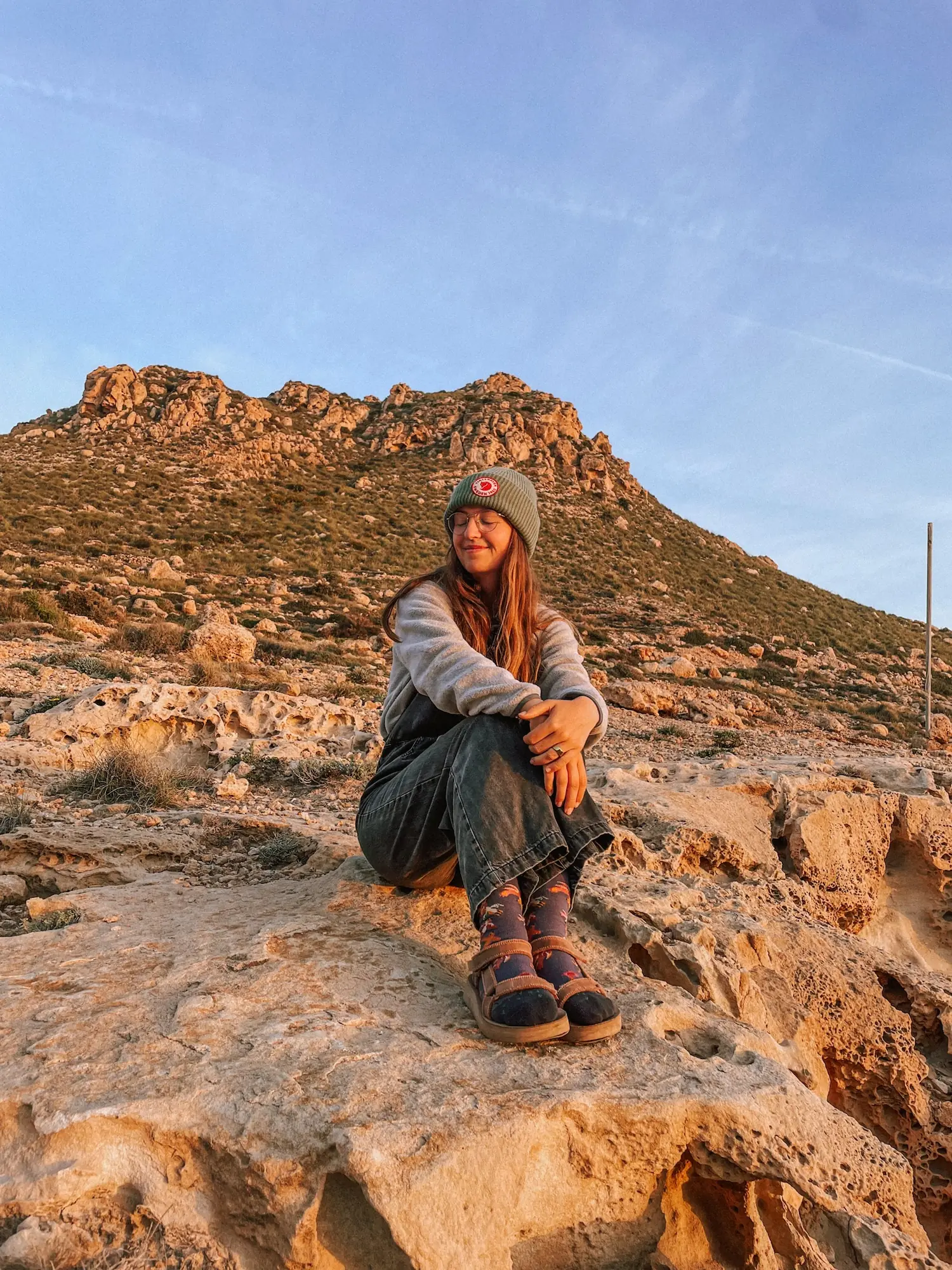 evelyne sitting on the rocks after a hike