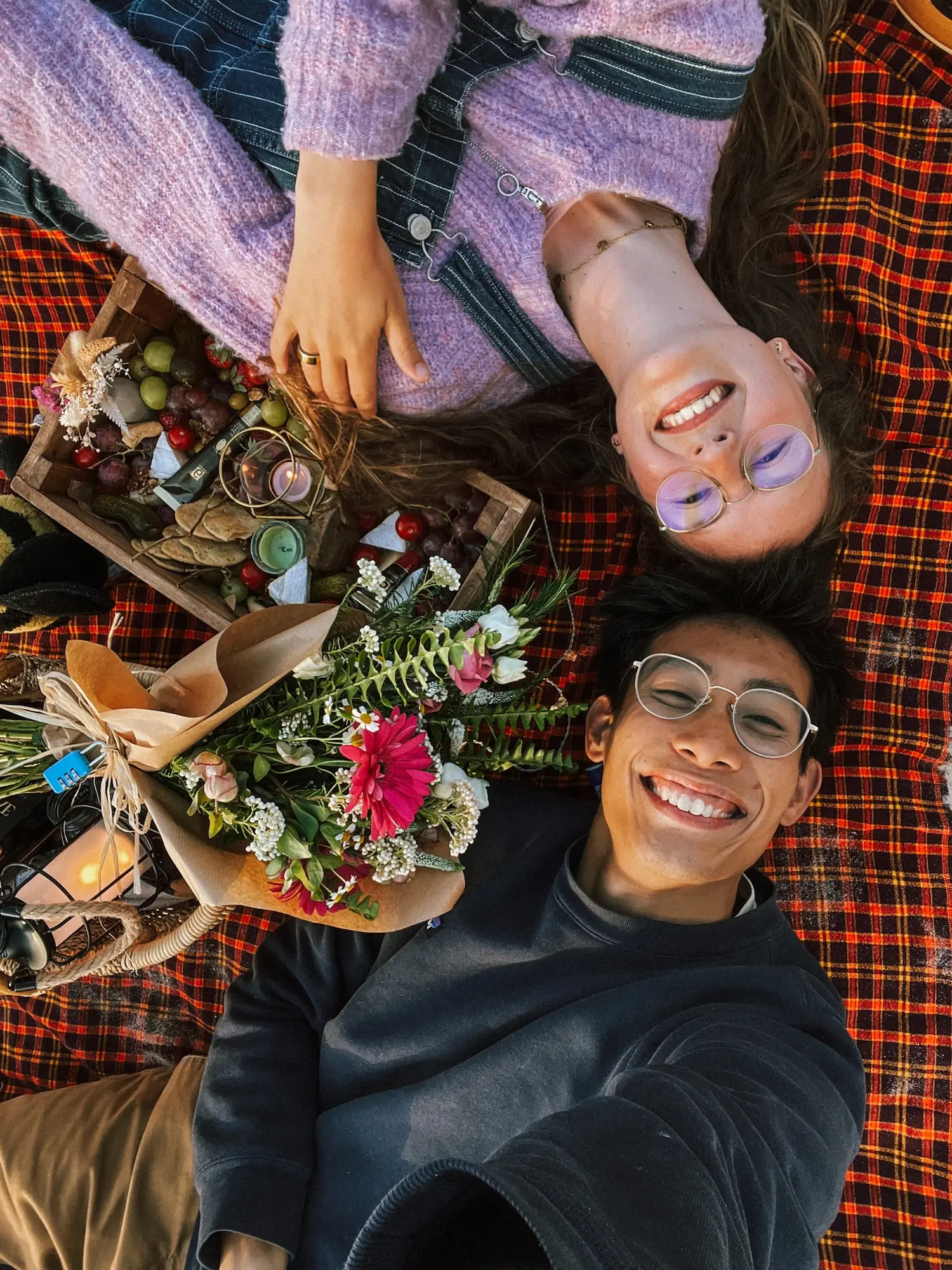 frank and evelyne lying on a picnic blanket
