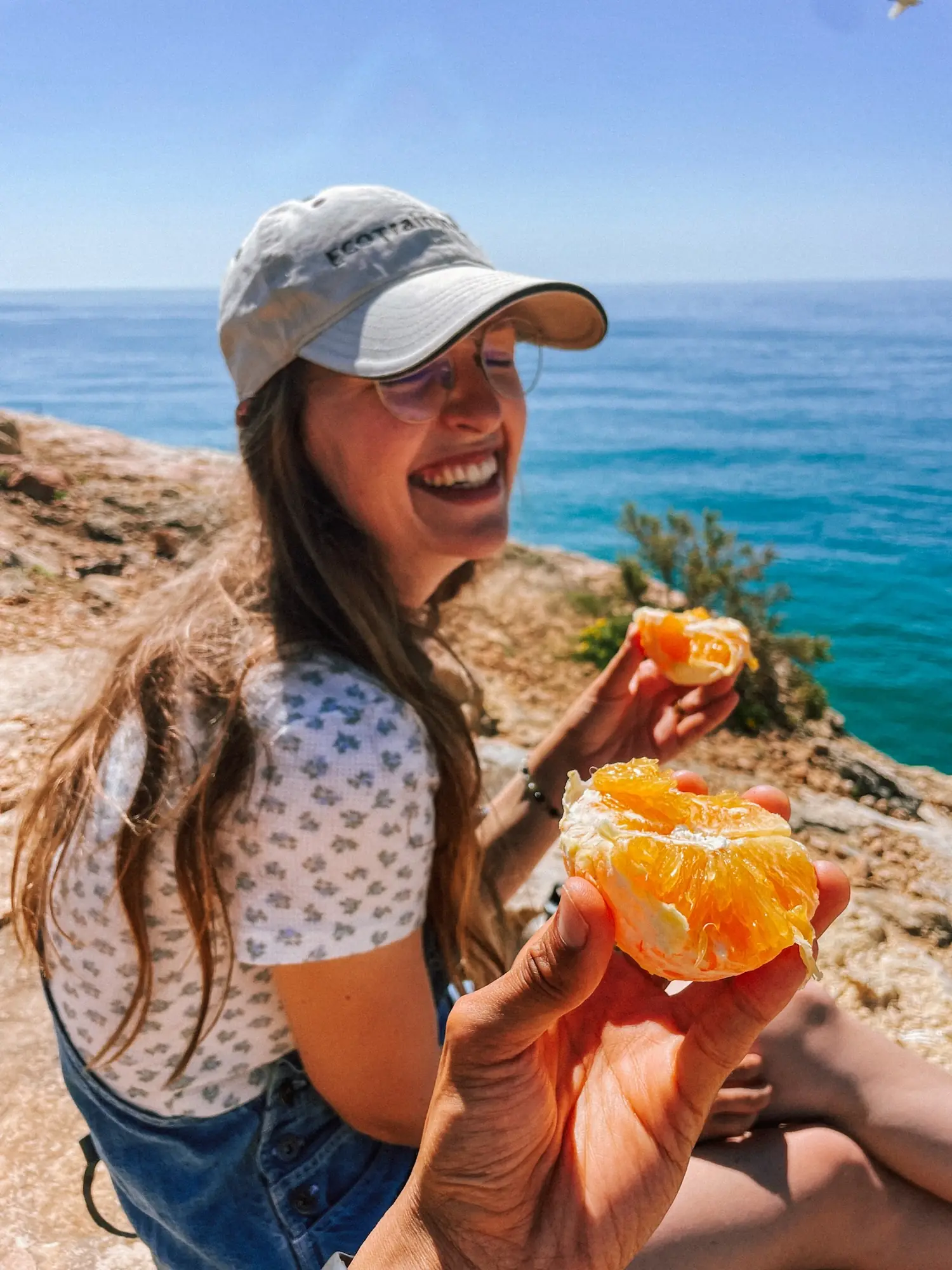 evelyne holding up an orange