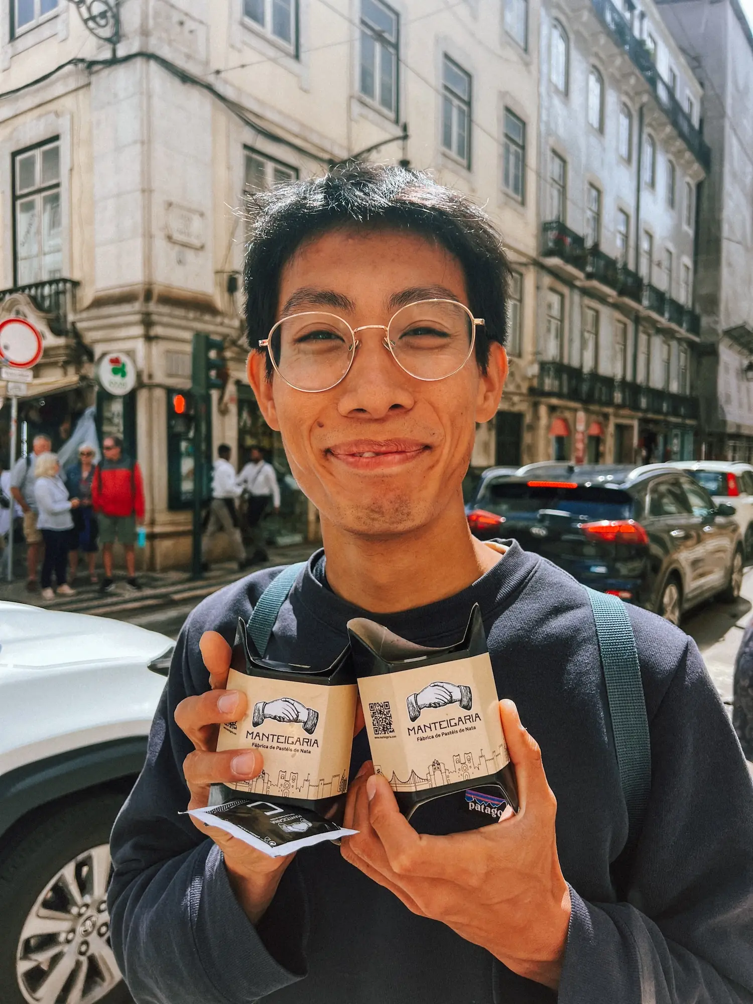 frank holding two pastéis de nata