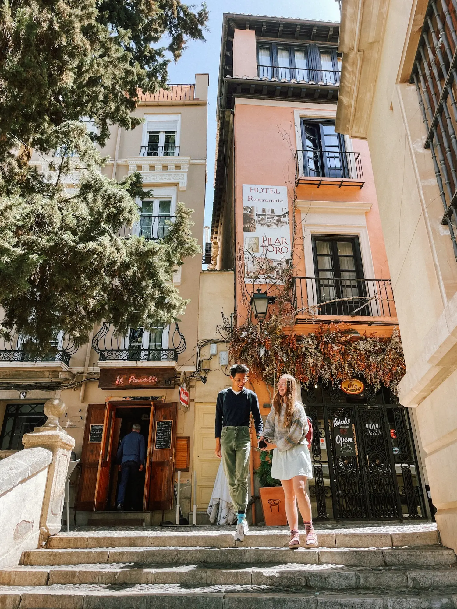 frank and evelyne on steps in a granada street