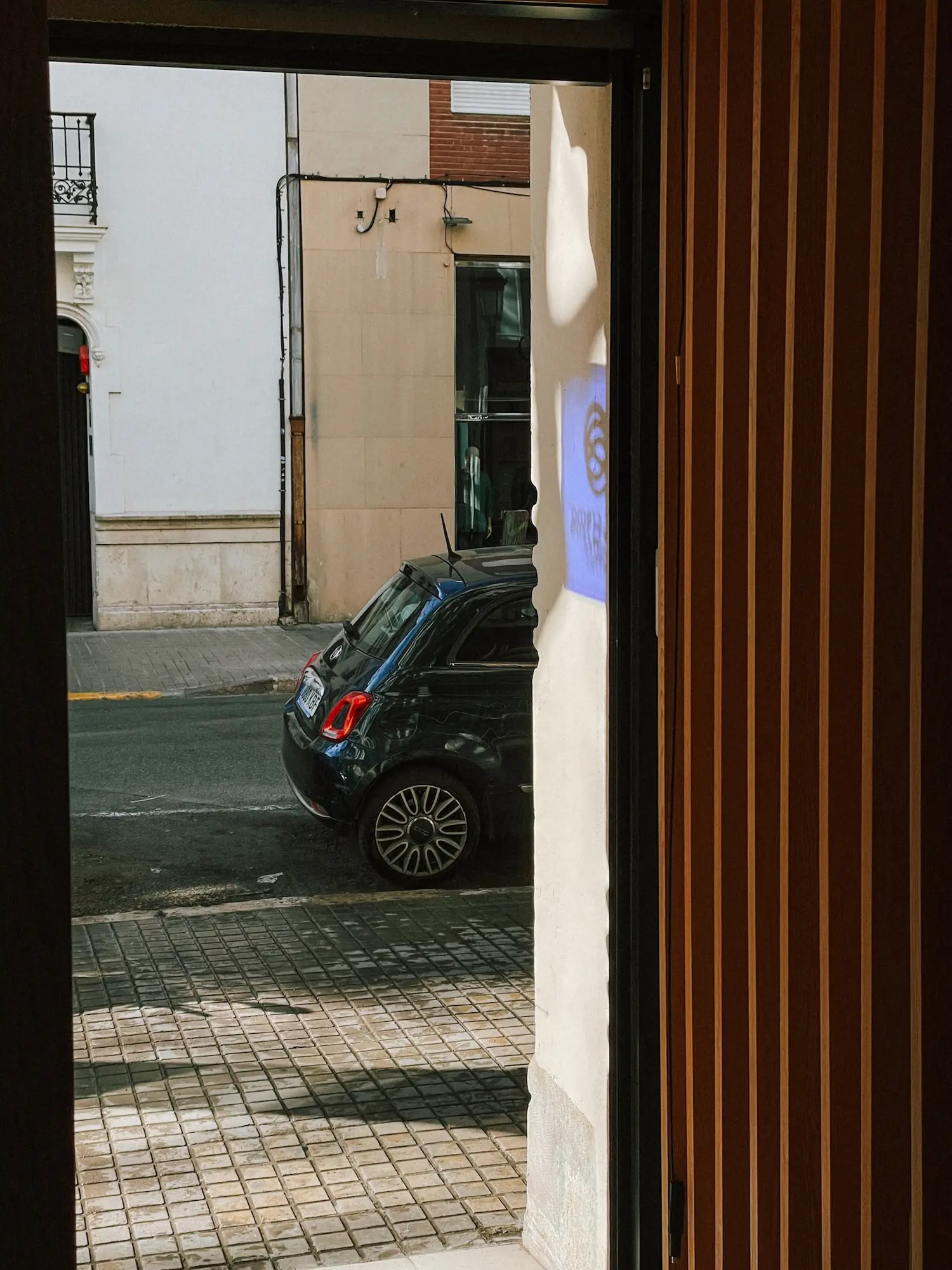 a view through a doorway onto a valencia street