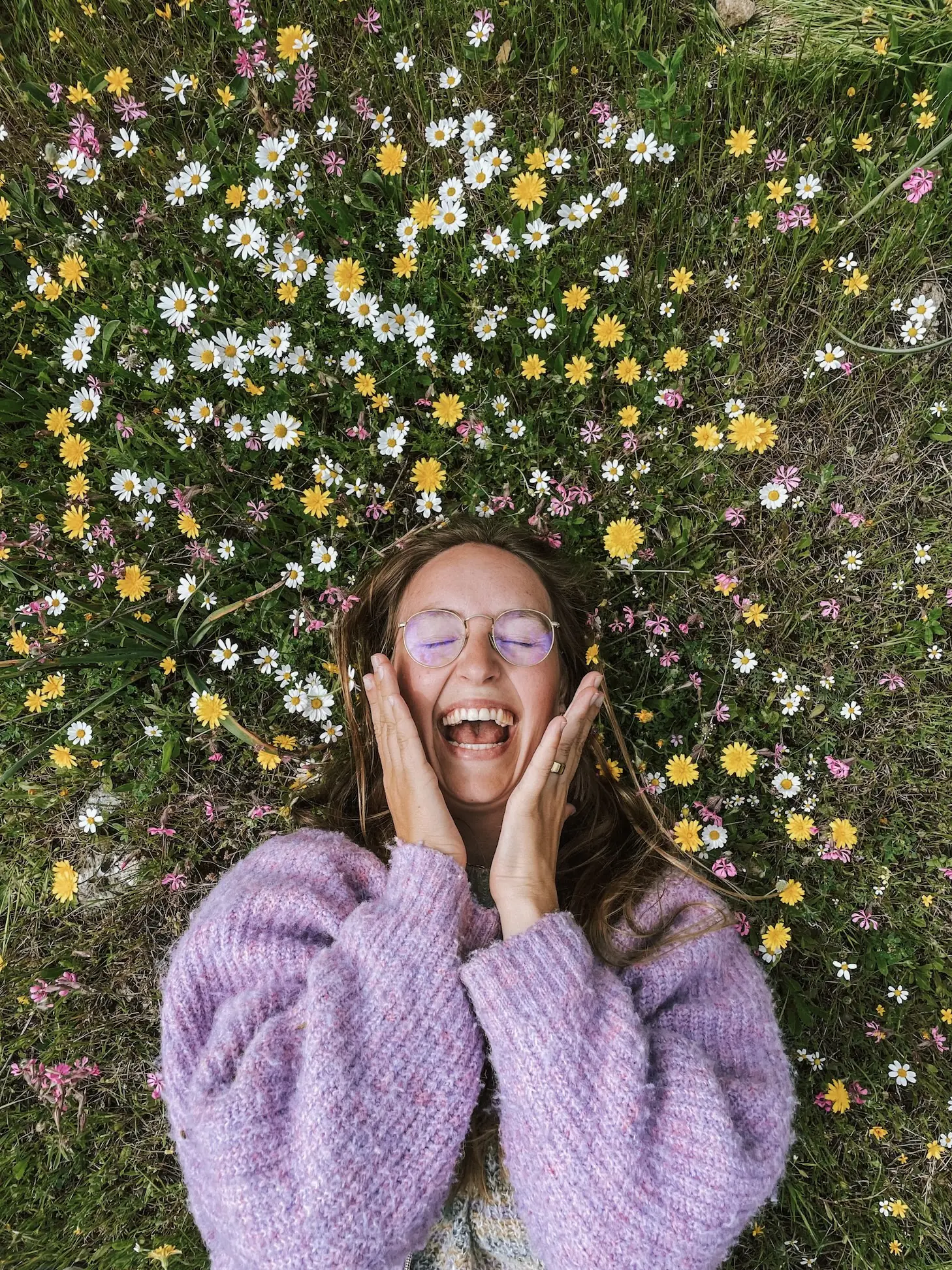 evelyne lying in a meadow of wildflowers