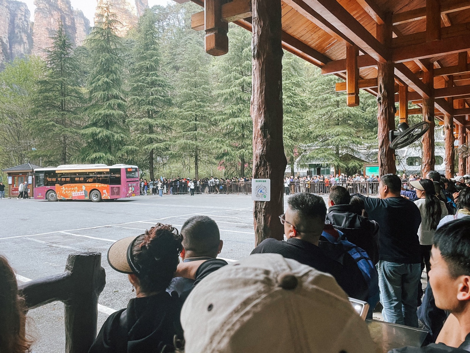 hundreds of people lining up (the chinese way) to catch the shuttle